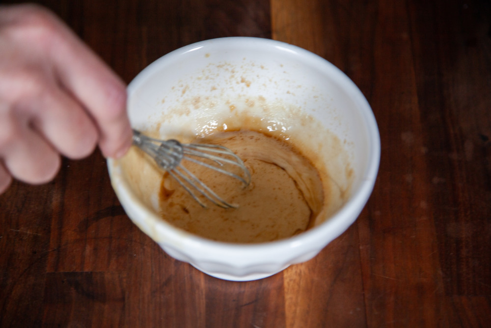 In a small bowl, whisk together tahini, sesame oil, rice wine vinegar, honey, and soy sauce. 