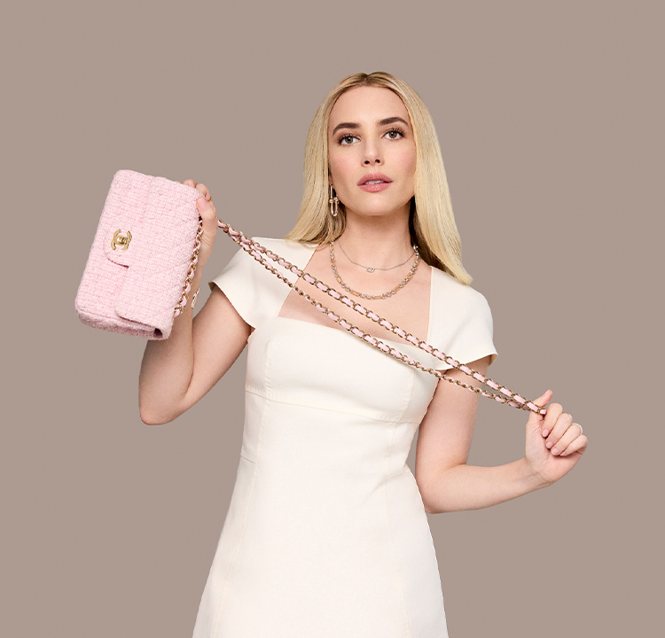 Emma Roberts in a white dress holding a pink tweed Chanel mini rectangular flap