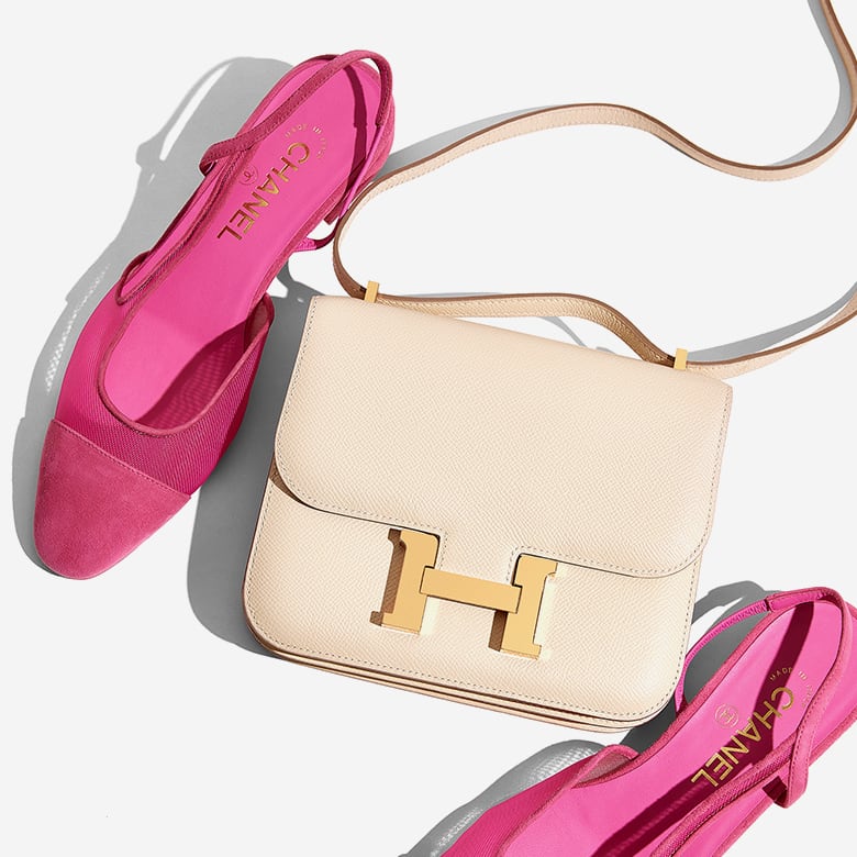 one pair of pink CHANEL CHANEL Mesh Suede Kidskin Cap Toe CC Slingback Pump next to one white Hermes Constance bag