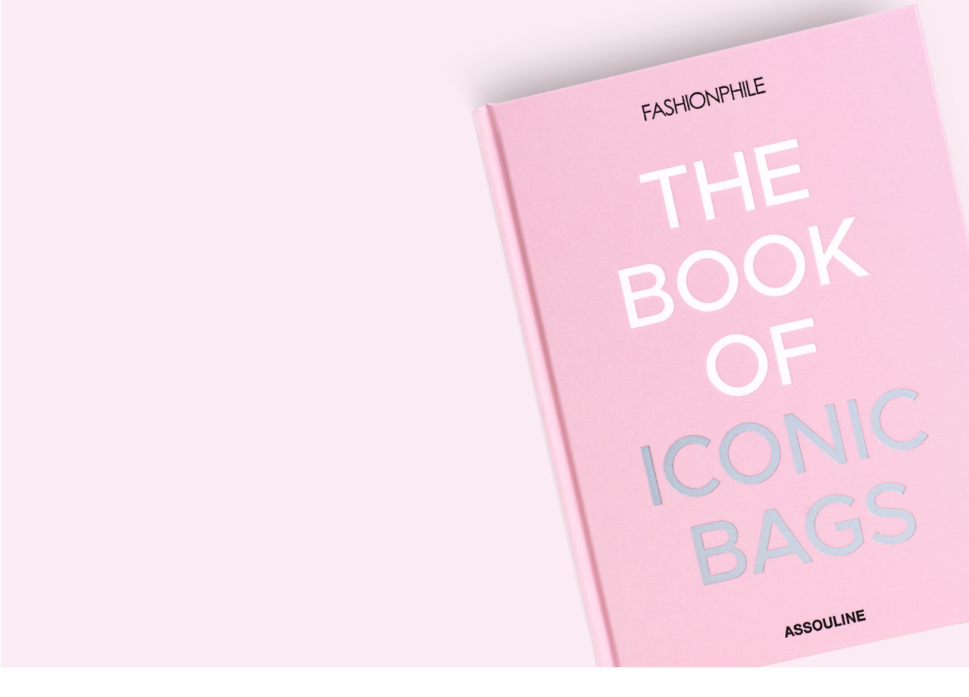 a pink hard cover book with the title FASHIONPHILE The Book of Iconic Bags ASSOULINE