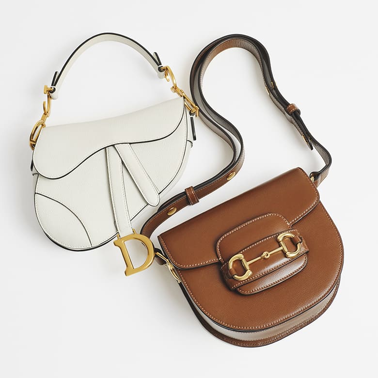 one white Christian Dior Saddle bag with gold-tone hardware and one brown Gucci horsebit saddle shoulder bag with gold-tone hardware