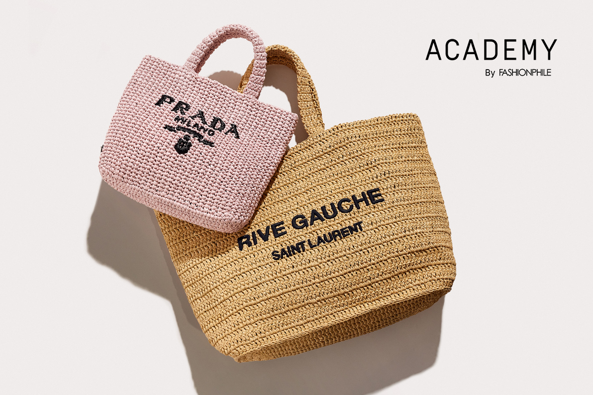 one pink raffia Prada tote lying next to one natural raffia Saint Laurent tote with "ACADEMY BY FASHIONPHILE" in black text