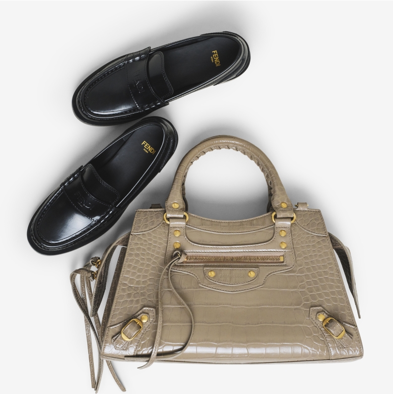 a pair of black Fendi penny loafers and one beige Balenciaga Neo City bag