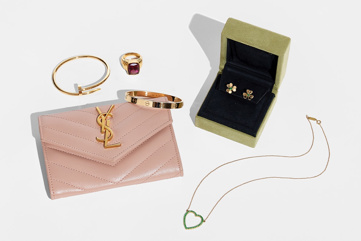 one pink YSL mini wallet, one gold Cartier Juste Un Clou bracelet, one gold Cartier Love bracelet, one pair of gold Van Cleef Alhambra earrings and one heart shaped pendant necklace