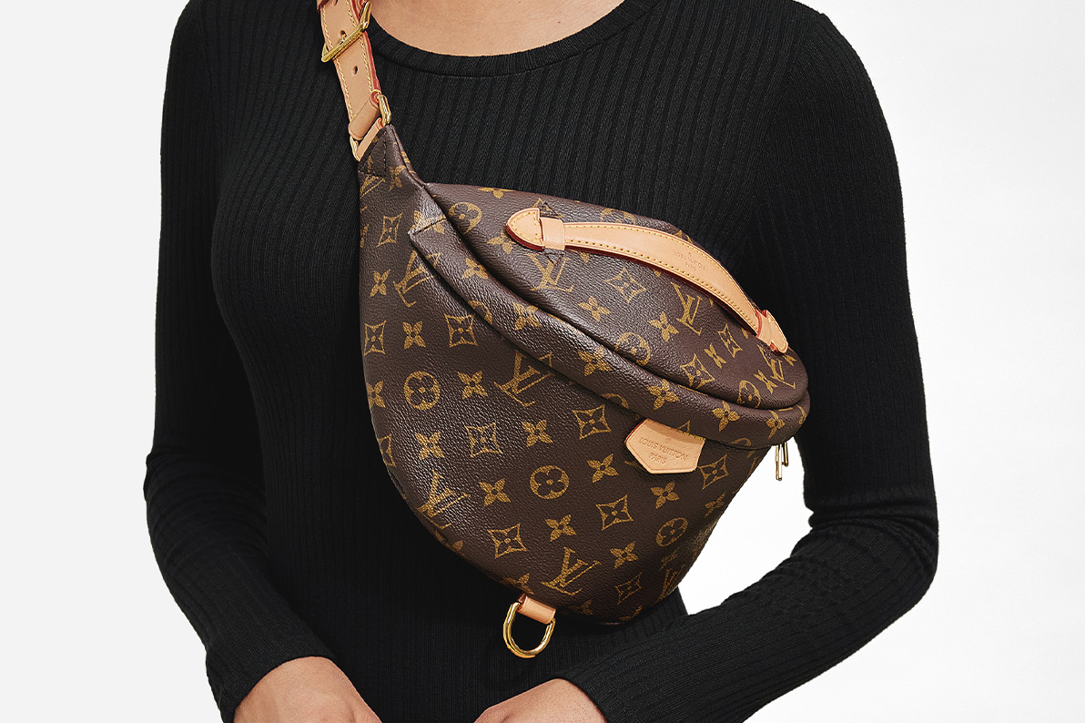 a woman in a black long sleeve dress wearing a LOUIS VUITTON Monogram Bumbag