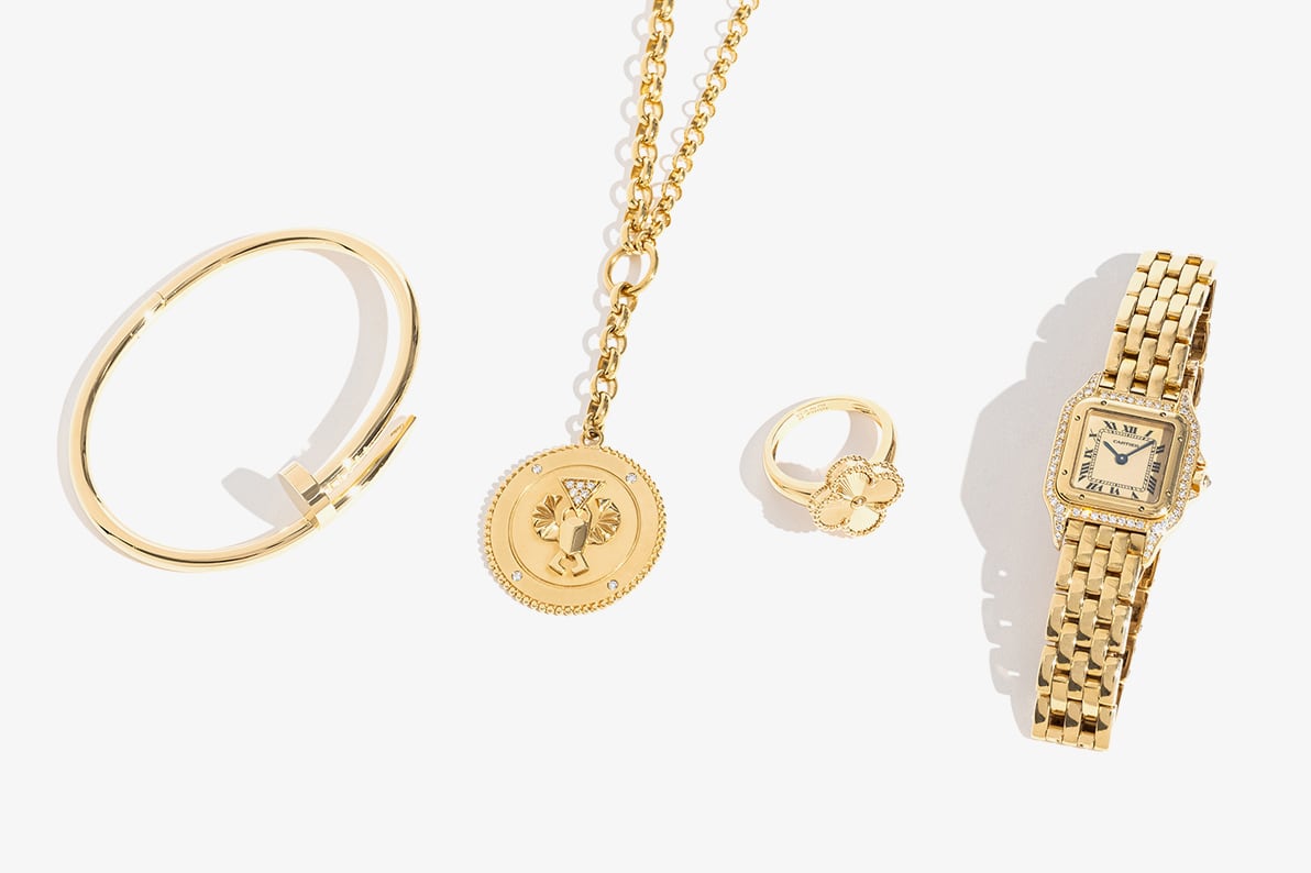 one CARTIER 18K Yellow Gold Small Juste Un Clou Bracelet lying next to one FOUNDRAE 18K Yellow Gold Medallion Extension Chain Necklace, one VAN CLEEF & ARPELS 18K Yellow Gold Vintage Alhambra Ring and one CARTIER 18K Yellow Gold Panthere Quartz Watch