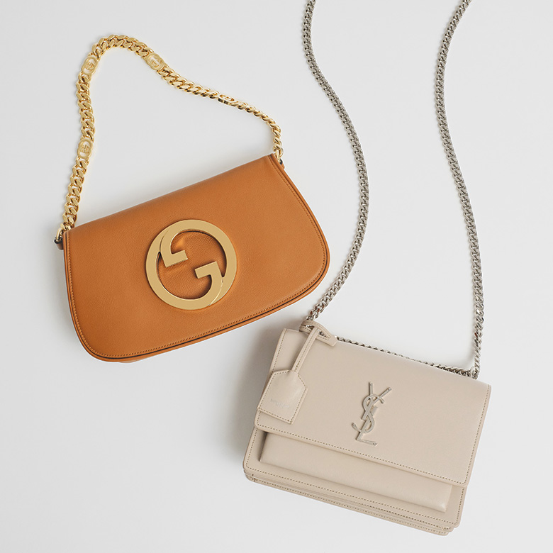 one Gucci Roxy Calfskin Blondie Chain Shoulder Flap Bag Blondie in Cognac color and one Saint Laurent Calfskin Medium Monogram Sunset bag in Marble Pink laying flat on a table