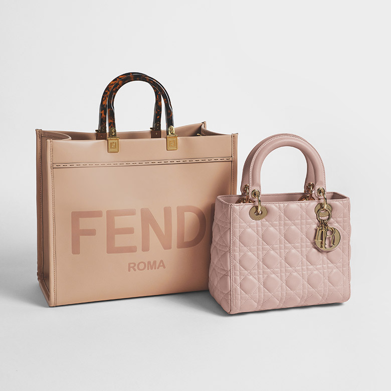 one beige Fendi Sunshine Shopper sitting next to one pink Christian Dior Lady Dior bag