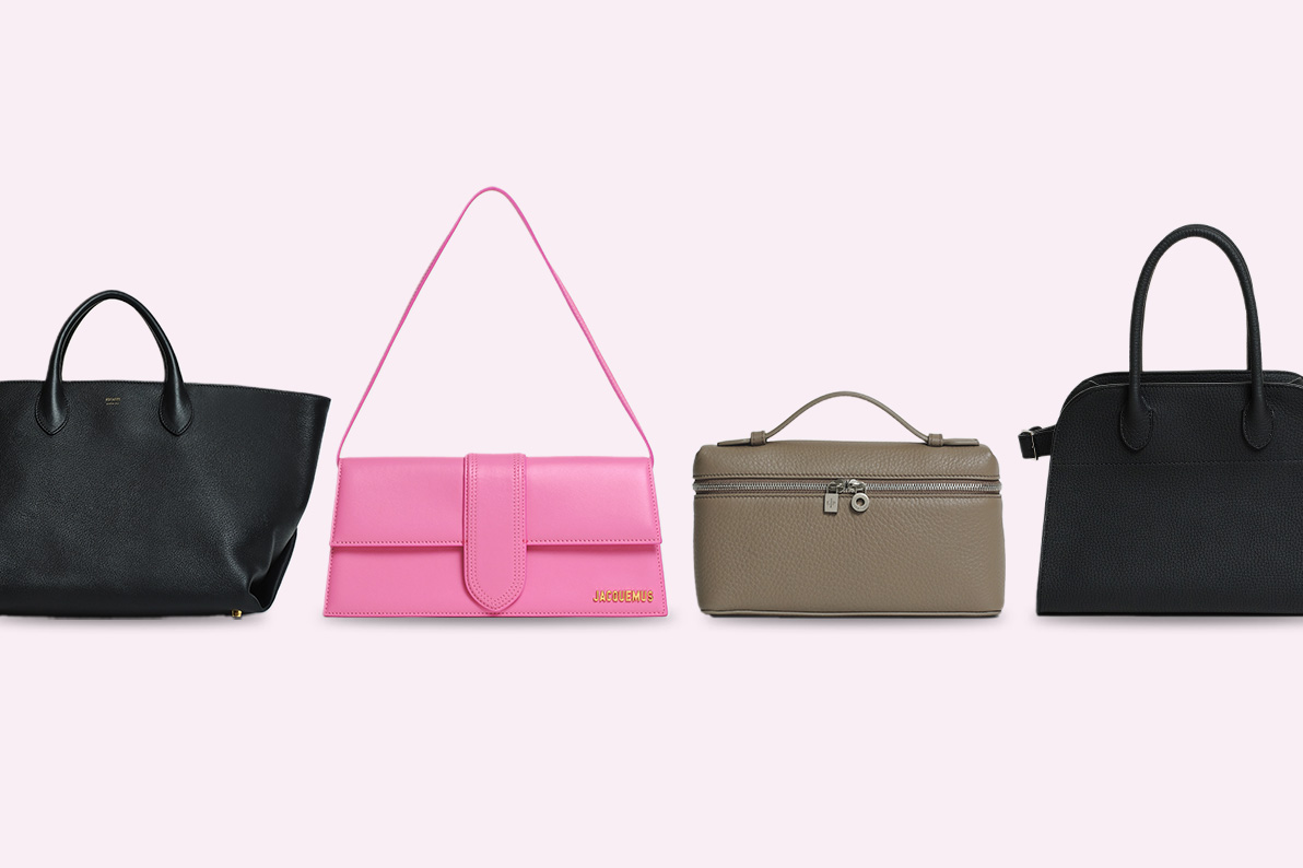 one black Khaite tote bag, one pink Jacquemus Le Bambino shoulder bag, one Loro Piana L19 grey bag, and one black The Row small Margaux tote bag all lined in a row against a light pink background