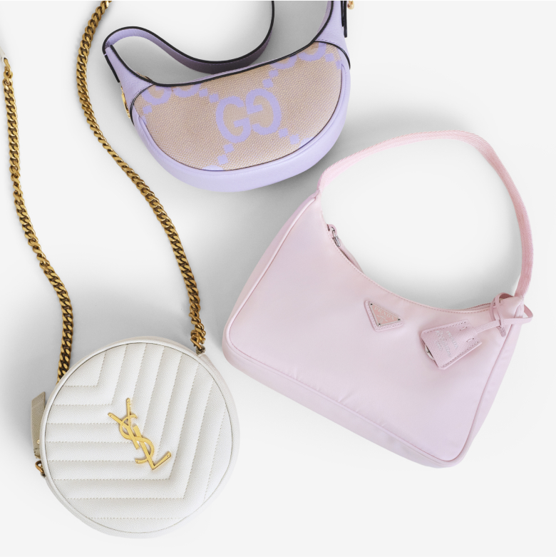 one white SAINT LAURENT  Chevron Quilted Round Camera Bag lying next to one light pink PRADA Tessuto Nylon Saffiano Re-Edition 2000 Bag  and one purple GUCCI Monogram Jumbo GG Textured Dollar Calfskin Mini Ophidia Half Moon Hobo 