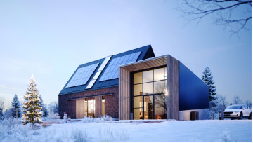 Haus mit Solarmodulen im Winter