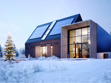 Haus mit Solaranlage im Winter