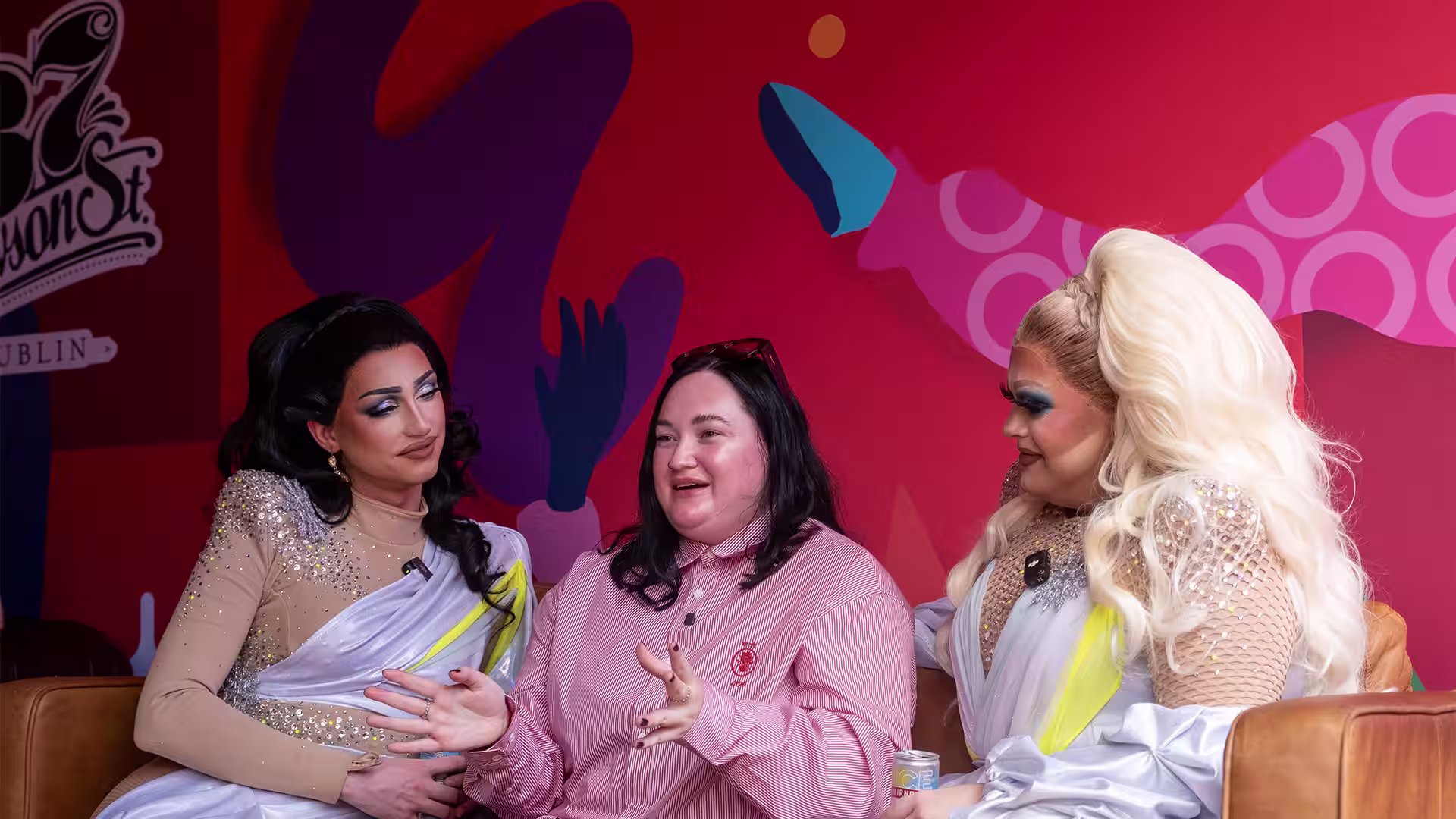 Three people in conversation on a lounge set beneath the word Inclusivity at a Smirnoff Sound Nation event.