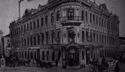 an old picture of a building with a clock on the front