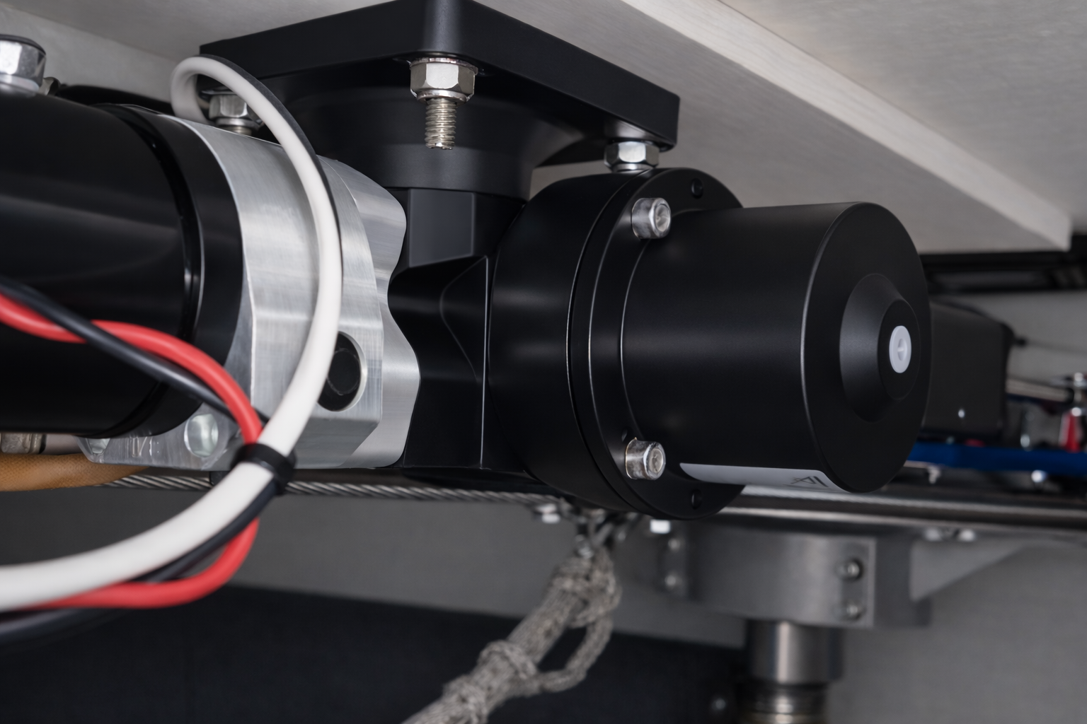A B&G Hydraulic RAM Drive that connects via a tiller arm to the rudder quadrant.