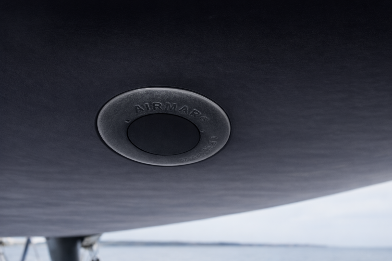 An Airmar ultrasonic tridata sensor under a clean and freshly painted hull.