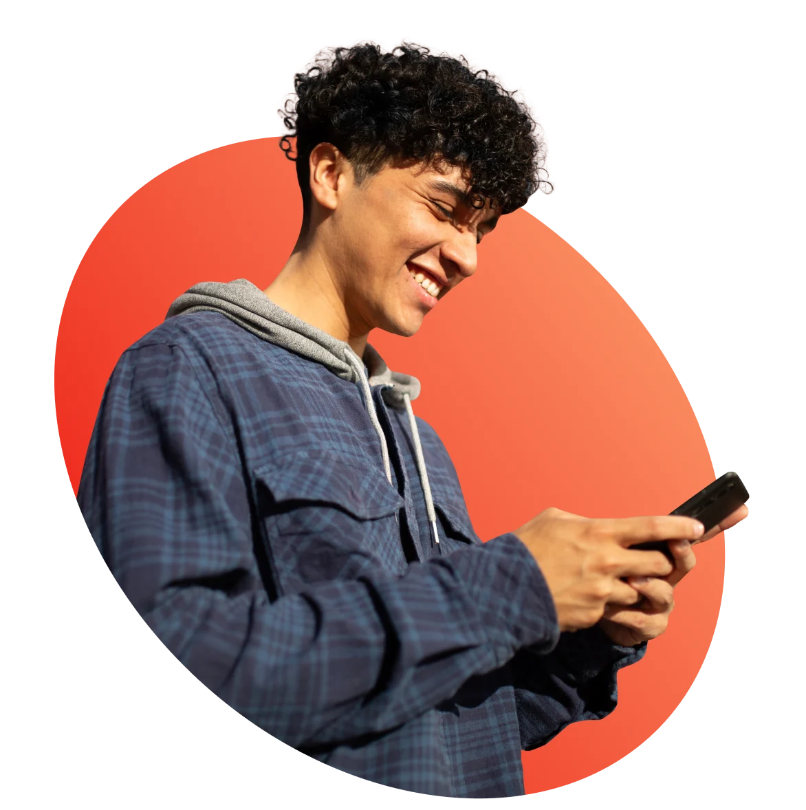 man smiling down at phone in hands
