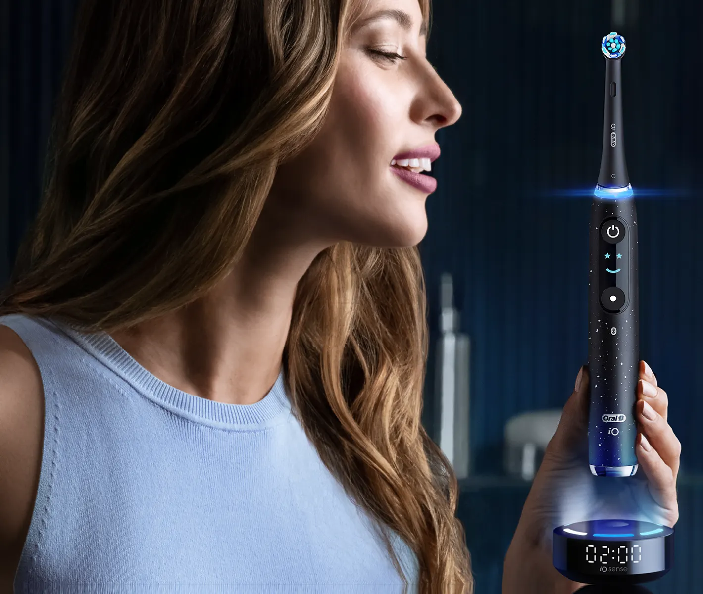 A lady holding Oral-B iO Electric Toothbrush