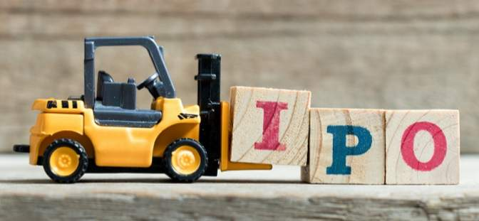 toy forklift moving wooden blocks with the letters IPO on them
