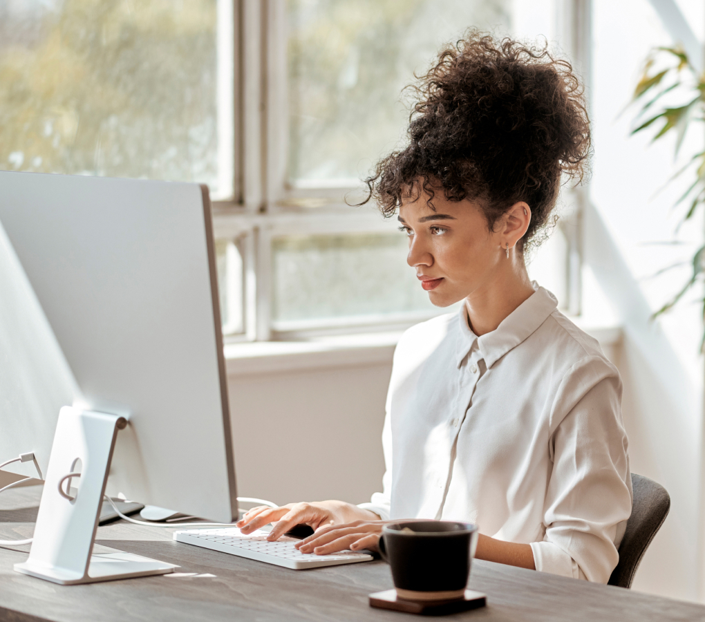 Image of woman at the office using a computer. 