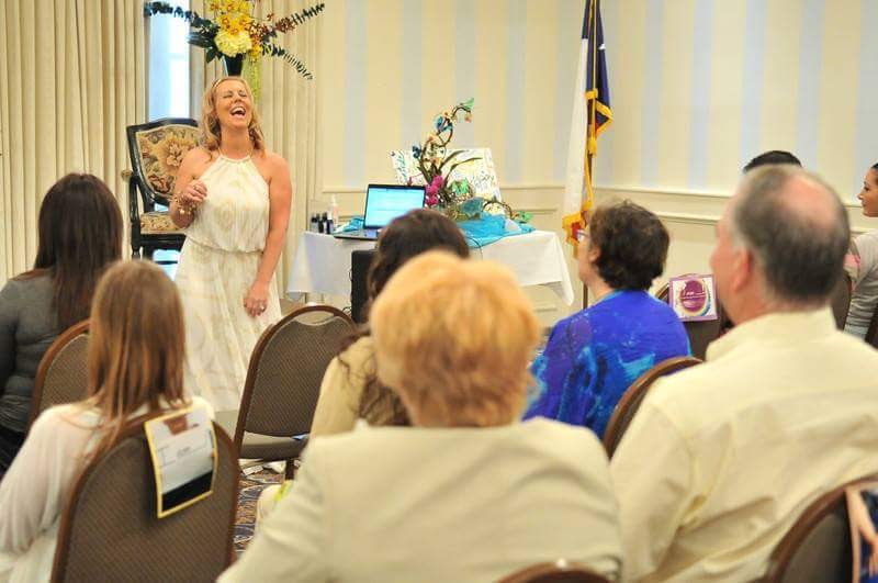 Janelle Hoyland Laughing While Speaking During An Event