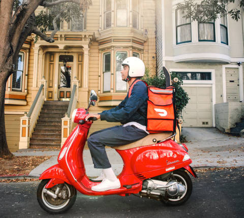 dasher on scooter with red hot bag