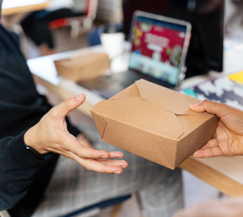 Someone receiving takeout for what could be a group meal