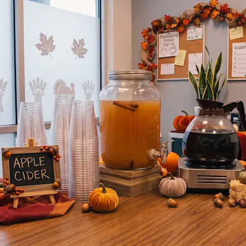 Apple cider and coffee pitchers at the office for a Thanksgiving potluck