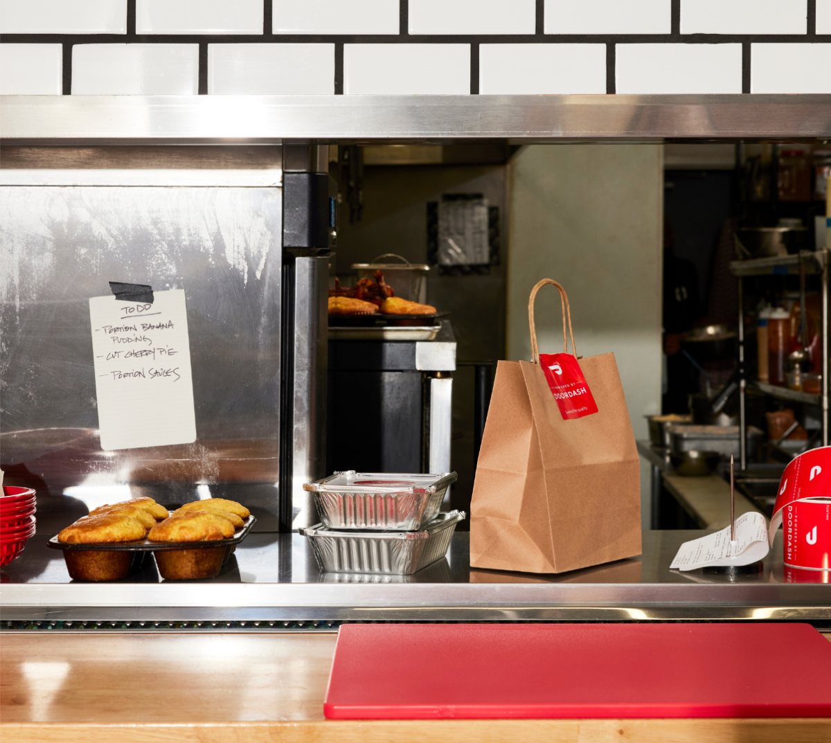 Counter at a restaurant with orders ready for dine-in and pickup with DoorDash