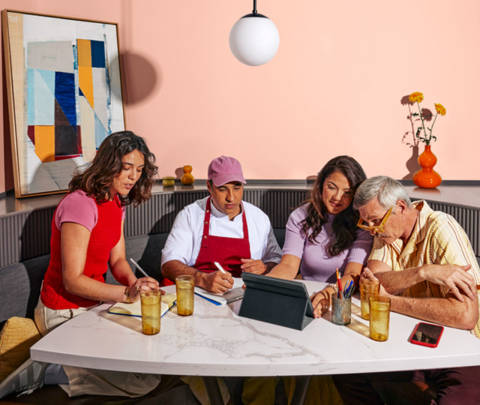 Kitchen staff looking at tablet