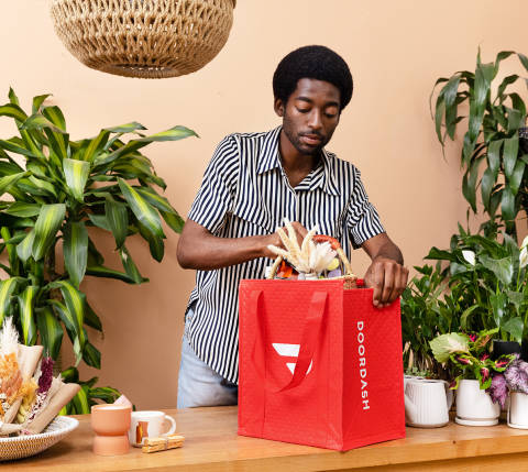 Employee puts plant in DoorDash bag