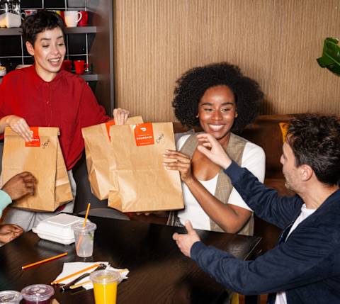 DDfB team eating lunch, passing out bags