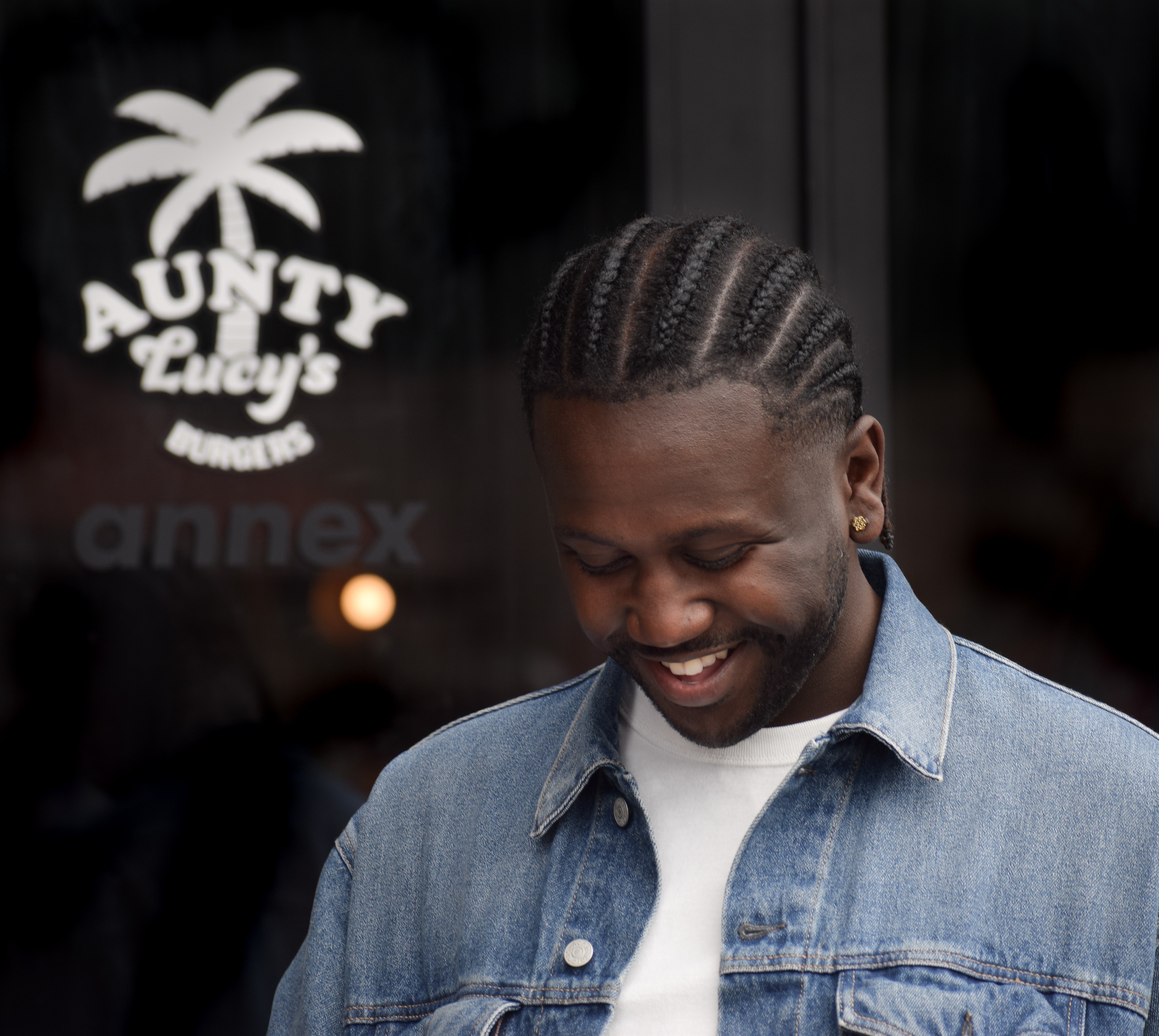 Owner of Aunty Lucy's Burgers outside of shop