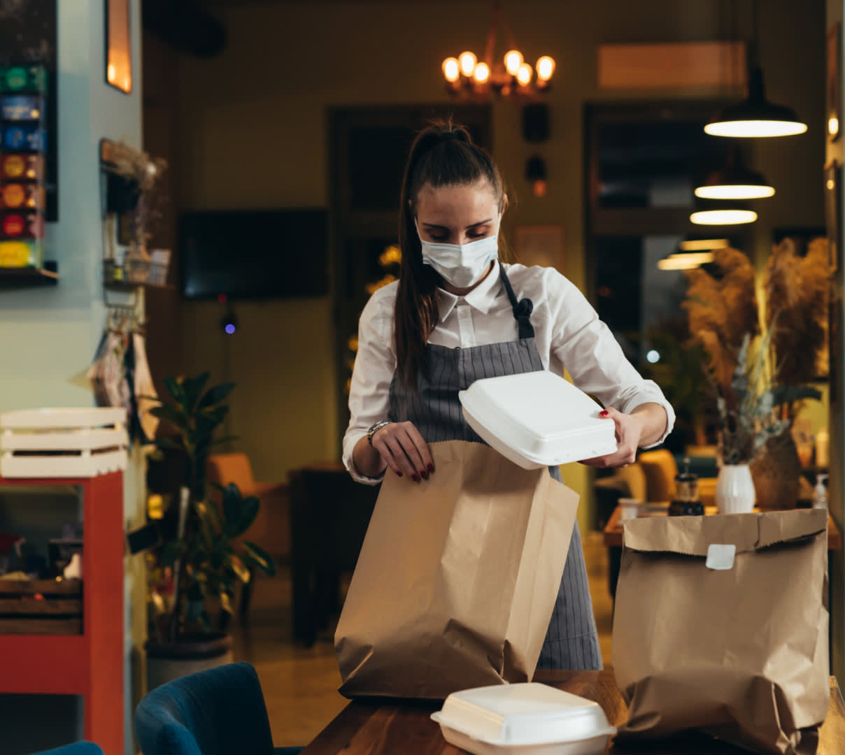 woman wearing mask with takeout