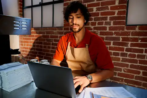 Male Restaurant owner working on his laptop