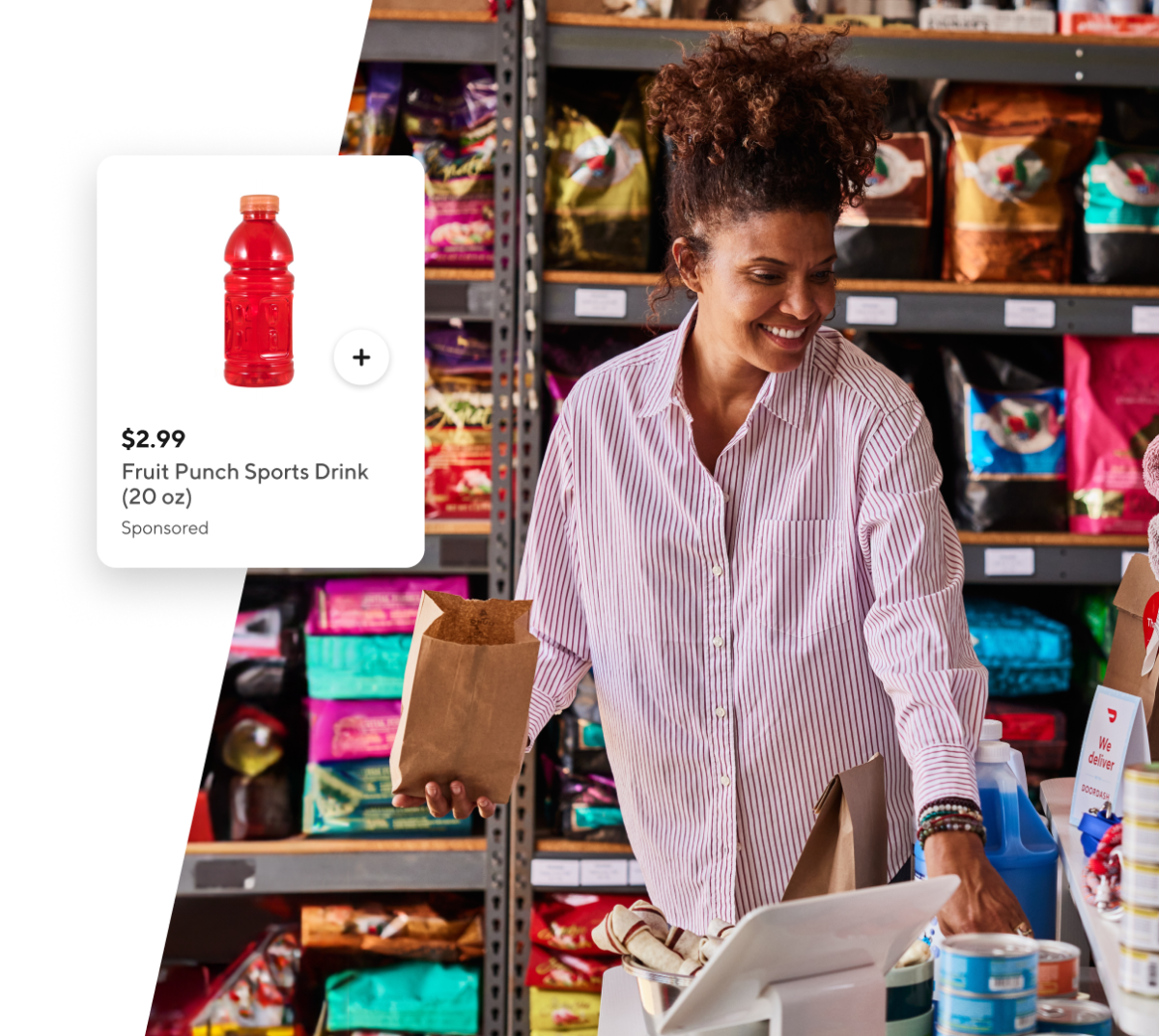 Women at the register of a store with a bag in her hand and an advertisement of a sports drink.