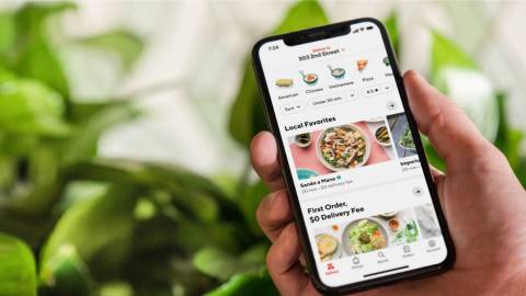 A hand scrolling on DoorDash, a third-party app