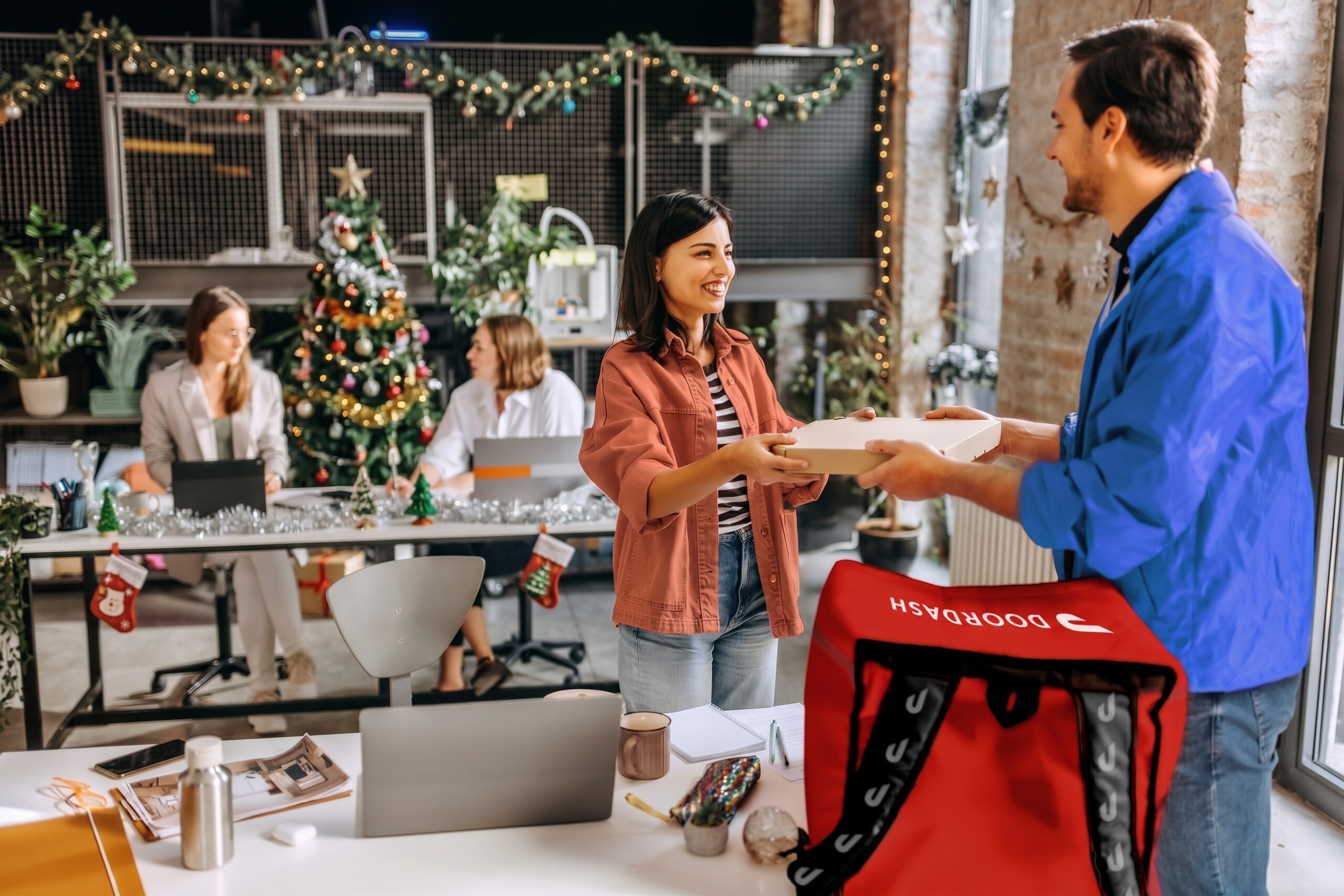 Dasher delivering a meal to a Christmas decorated office