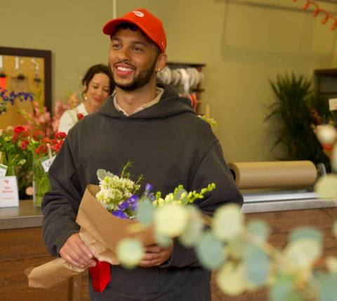 Dasher with a bouquet leaving flower shop