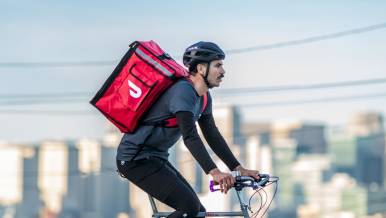 Dx - Blog - Rules of the Road: An Experienced Dasher’s Guide to Bike Safety - Bike Dasher with bag