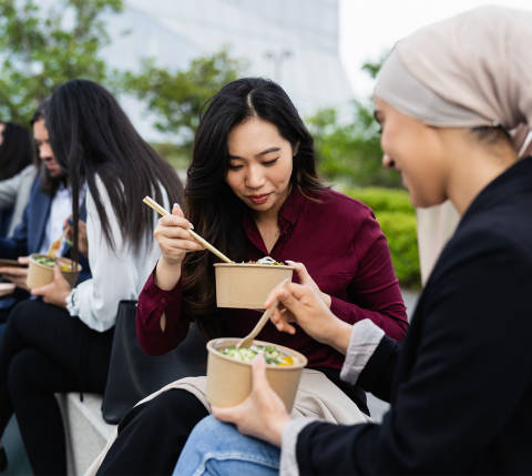 DDfB - Blog - How to Celebrate Cultural Diversity in the Workplace Through Food - employees eating outside with chopsticks