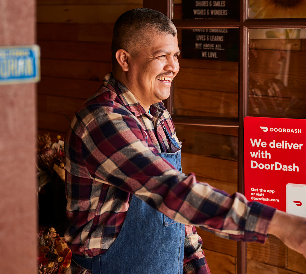 Merchant with DoorDash sign