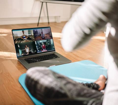 DDfB - Blog - 31 Corporate Perks Employees Really Want at Work - open laptop with other yoga participants