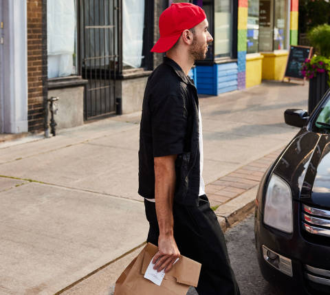 Dasher with delivery bag by car