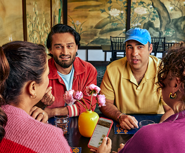 People gathered around table with phone 