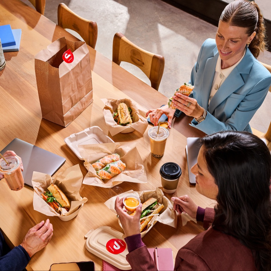 A group of people eating at their office