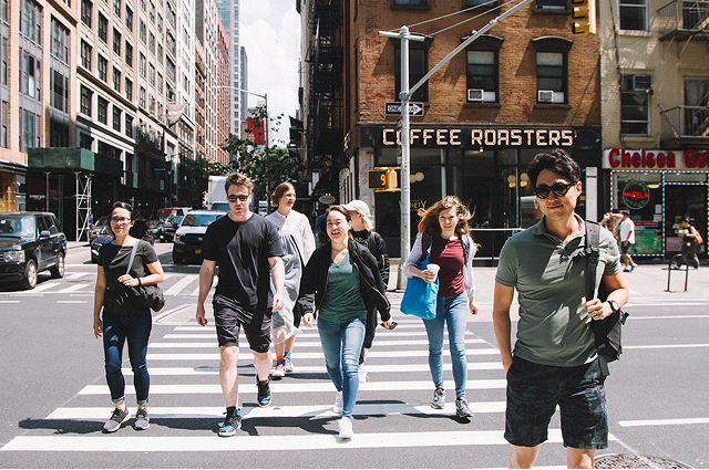MCD employees in Manhattan crossing the street together.