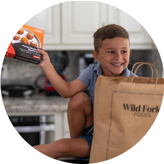 Boy pulling food out of bag 326 x326 png