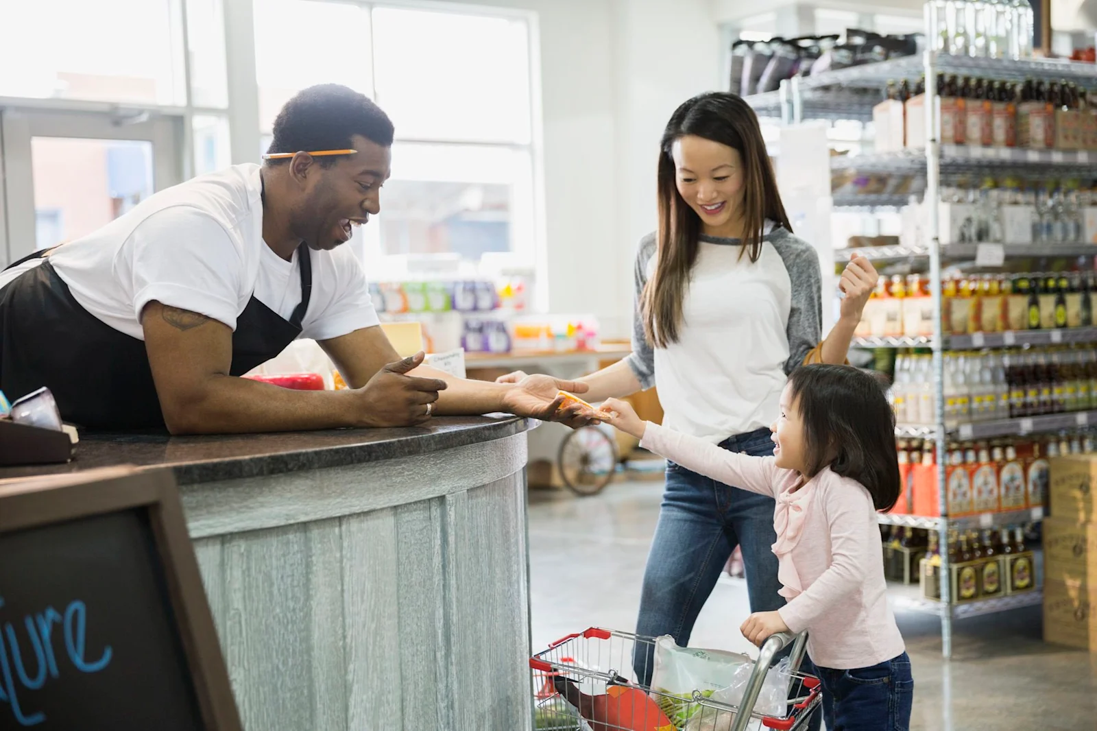 a kid paying in a grocery store