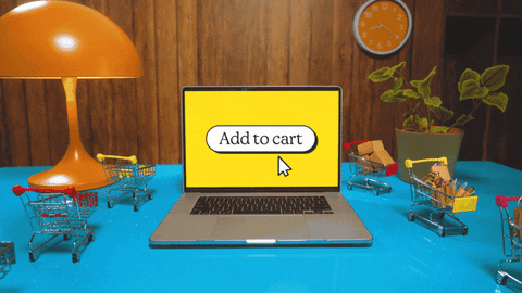 a laptop screen showing "add to cart" with small toy carts